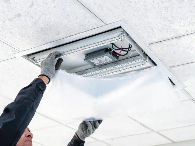 Technician accessing a replaceable LED driver